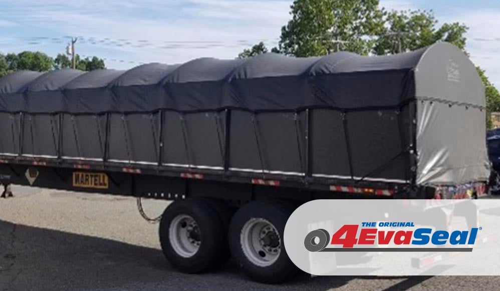 truck cargo covered by a dark gray tarp